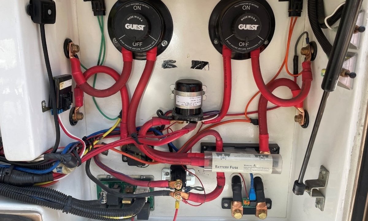 Battery wiring panel with two disconnect switches, a solenoid relay, and a battery fuse
