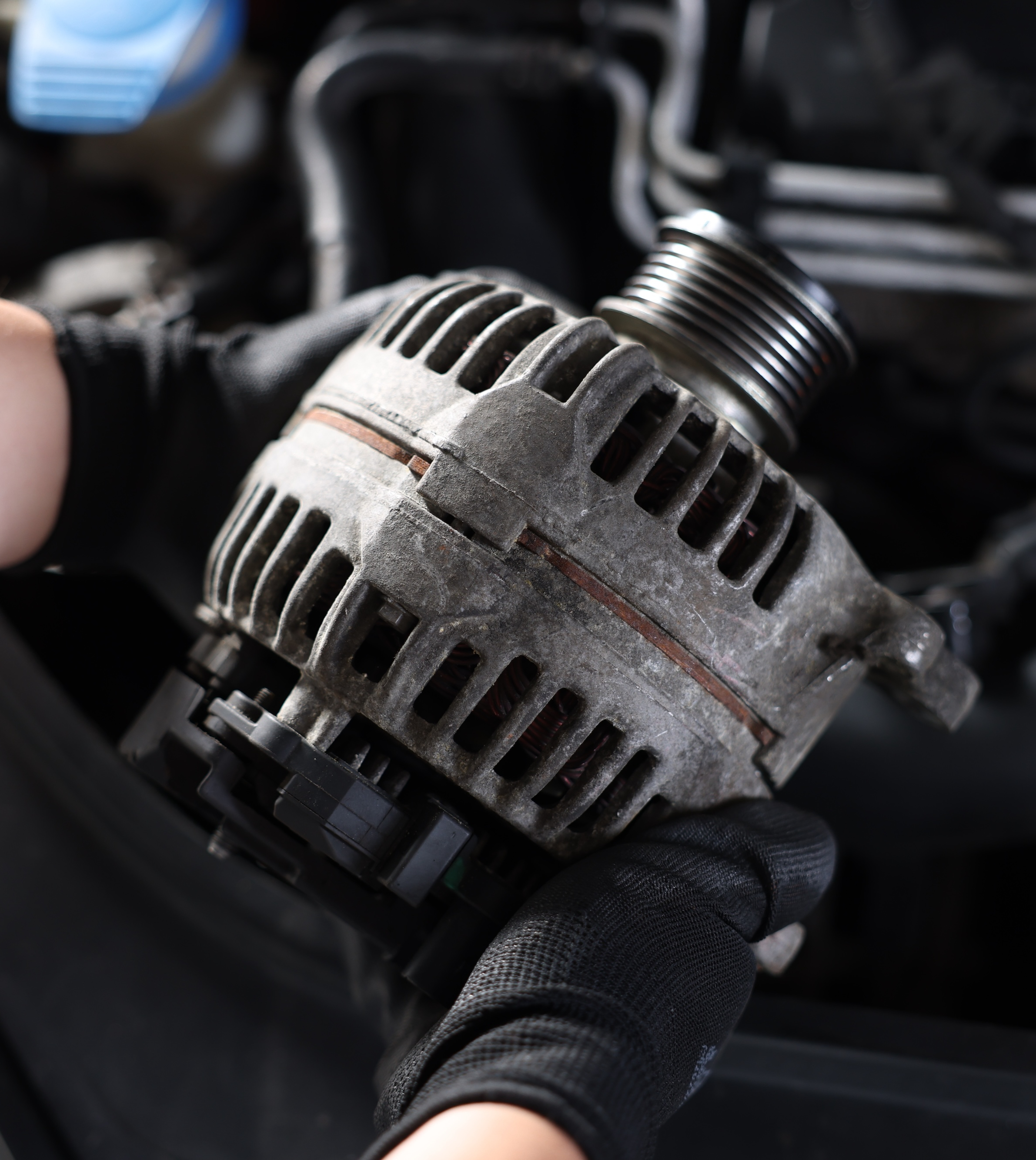 New alternator installed with the serpentine belt in a car engine