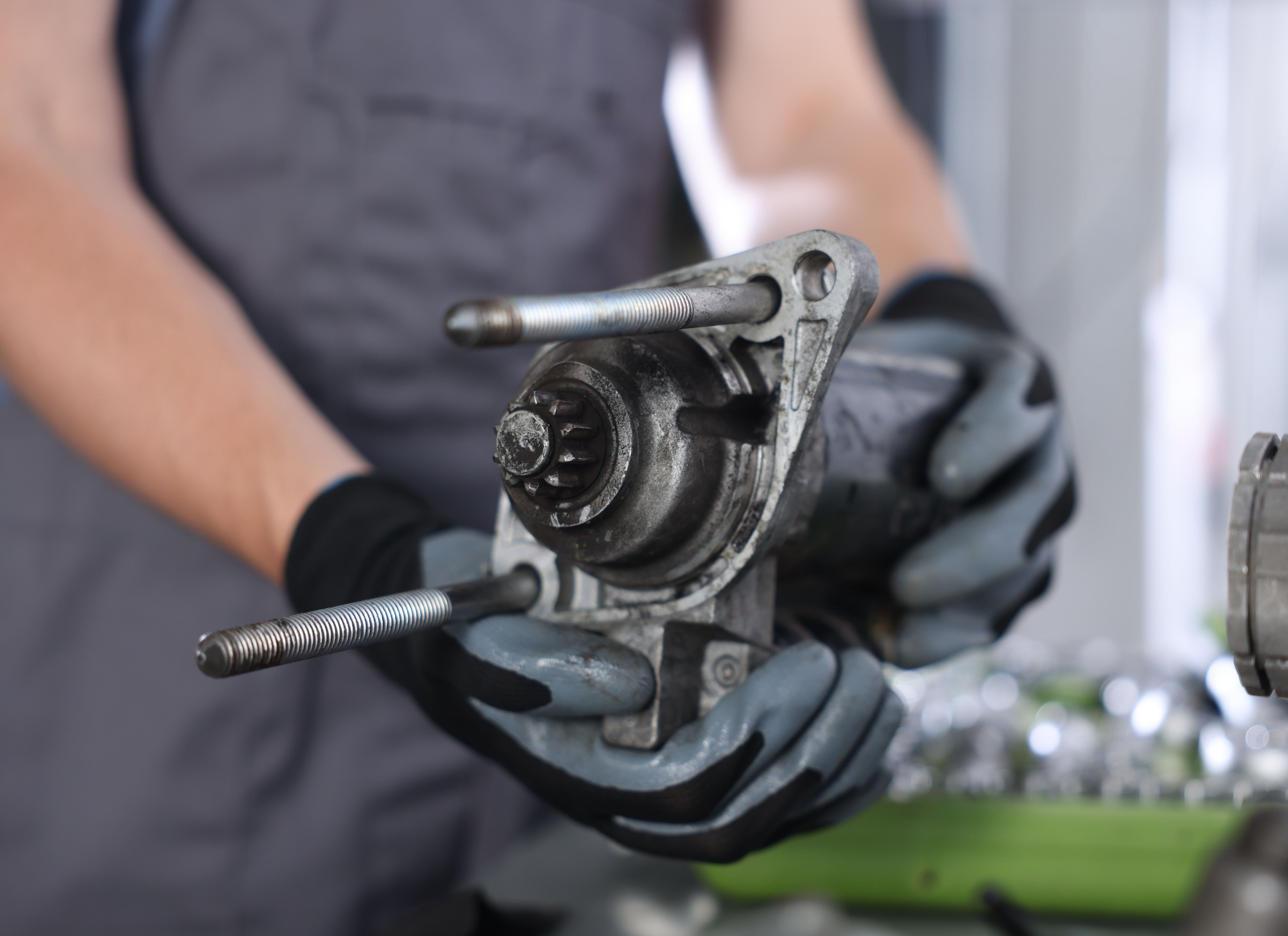 Close-up inspection of a worn starter motor pinion gear