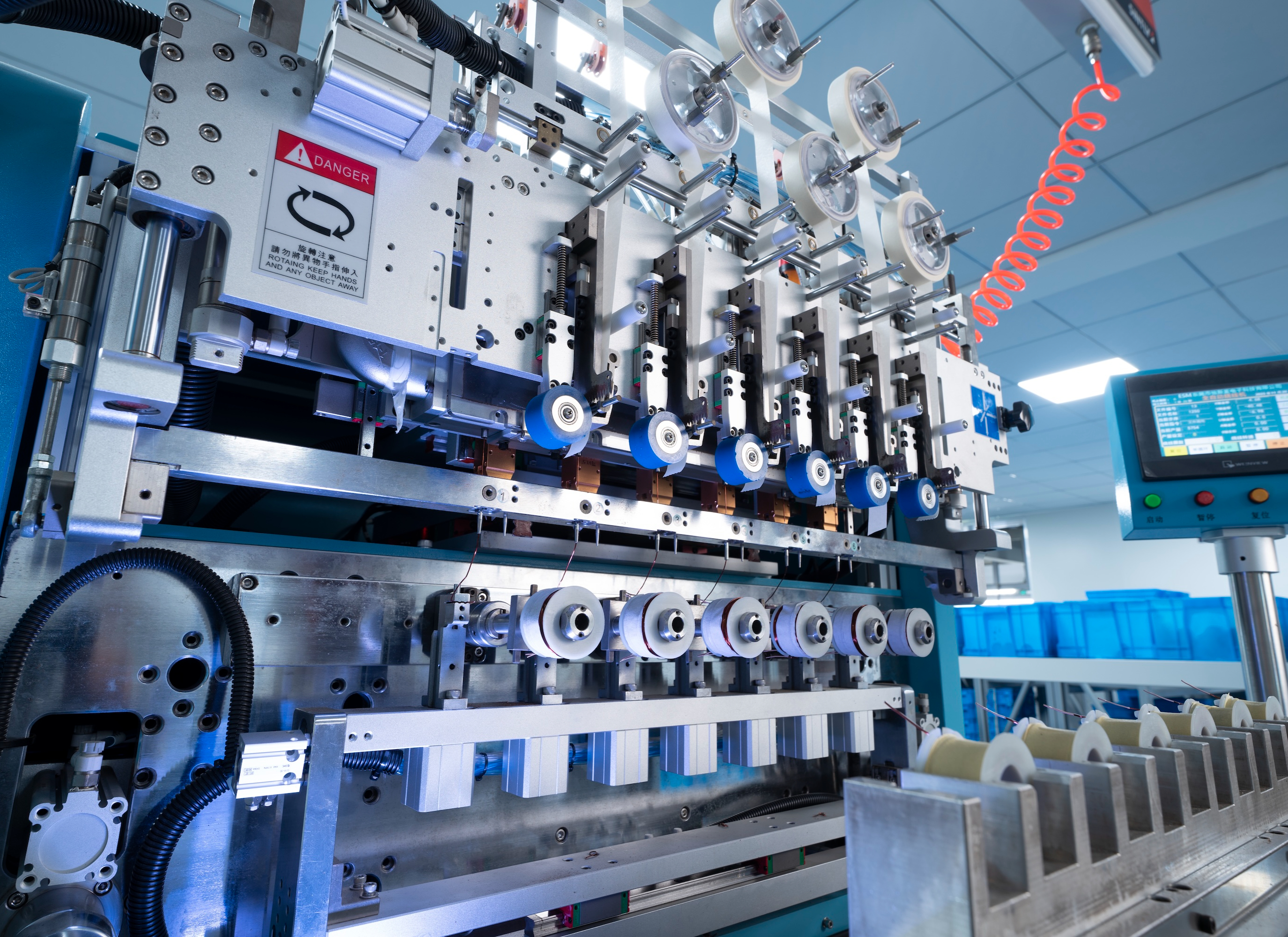 Automated multi-spindle coil winding machine on an automotive parts production line