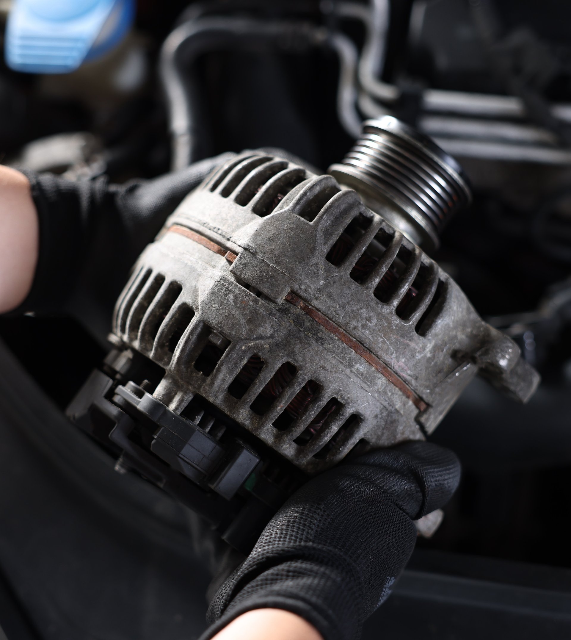 New alternator installed with the serpentine belt in a car engine