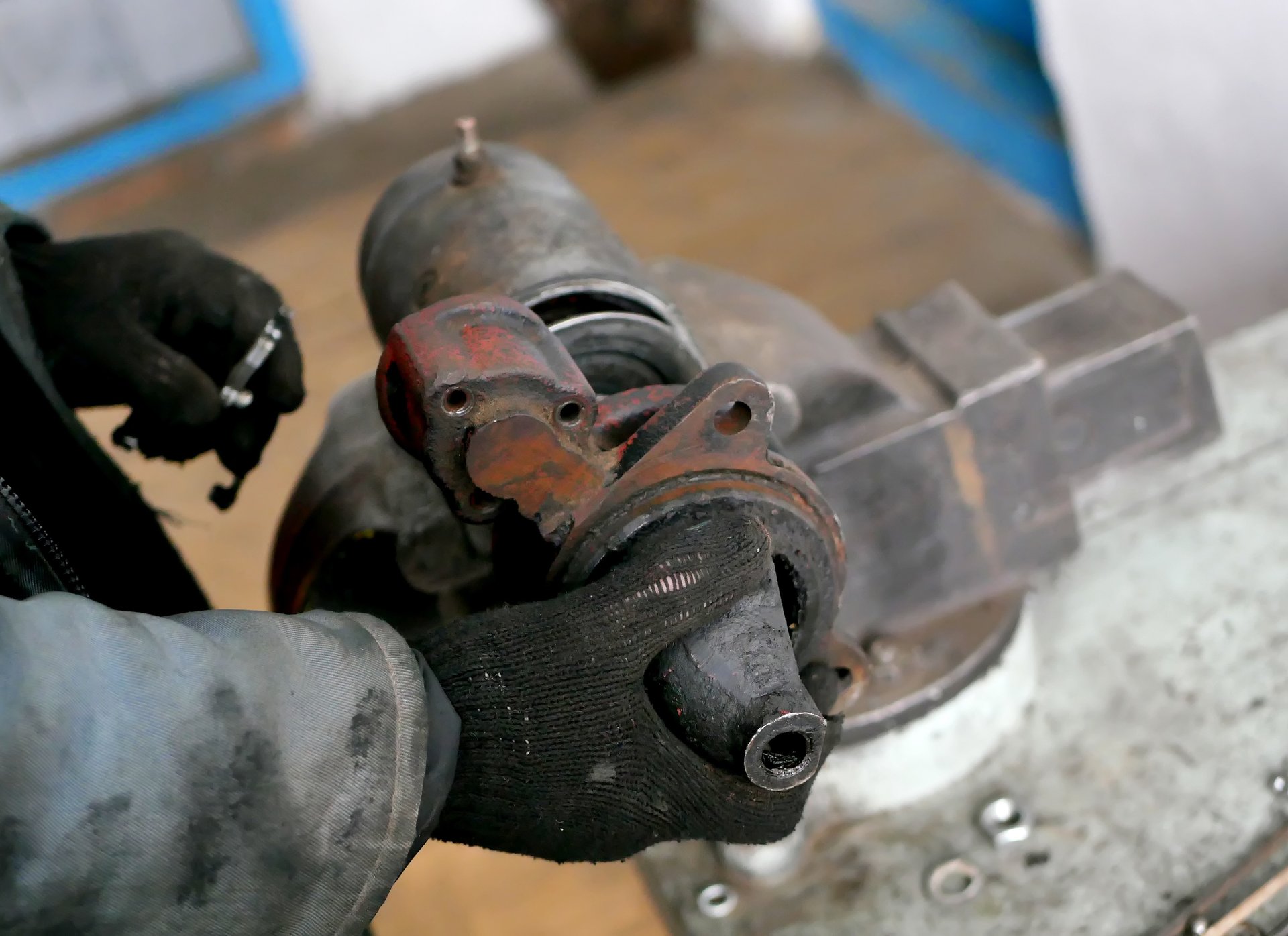 Mechanic inspecting a worn starter motor during repair